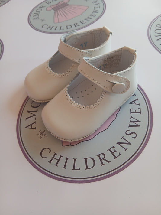 Girls cream button mary jane pram shoes on Amor Bambino childrenswear brand logo.