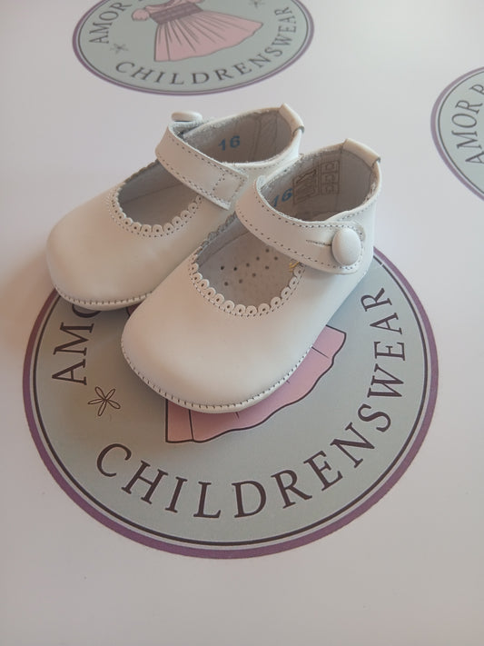 Girls white button mary jane pram shoes on Amor Bambino childrenswear brand logo.