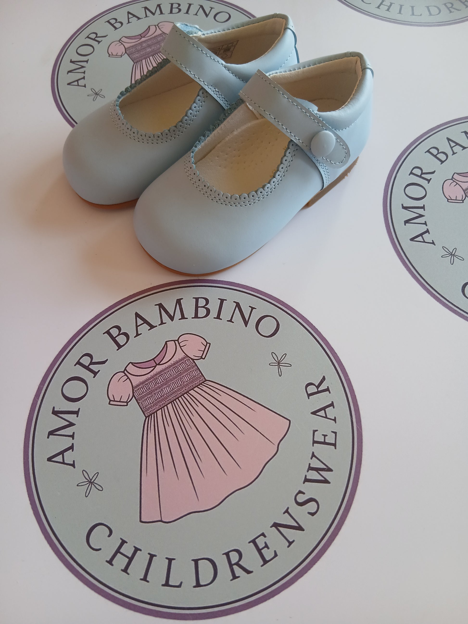 Girls baby blue button matte mary jane shoes on amor Bambino childrenswear brand logo